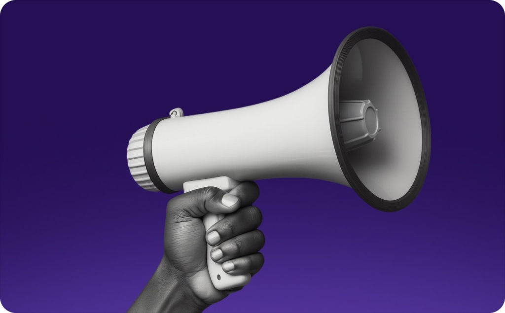 A hand holding a megaphone on purple background