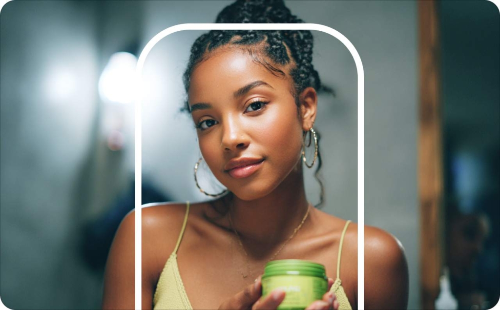 A woman with cream in her hands watching the mirror